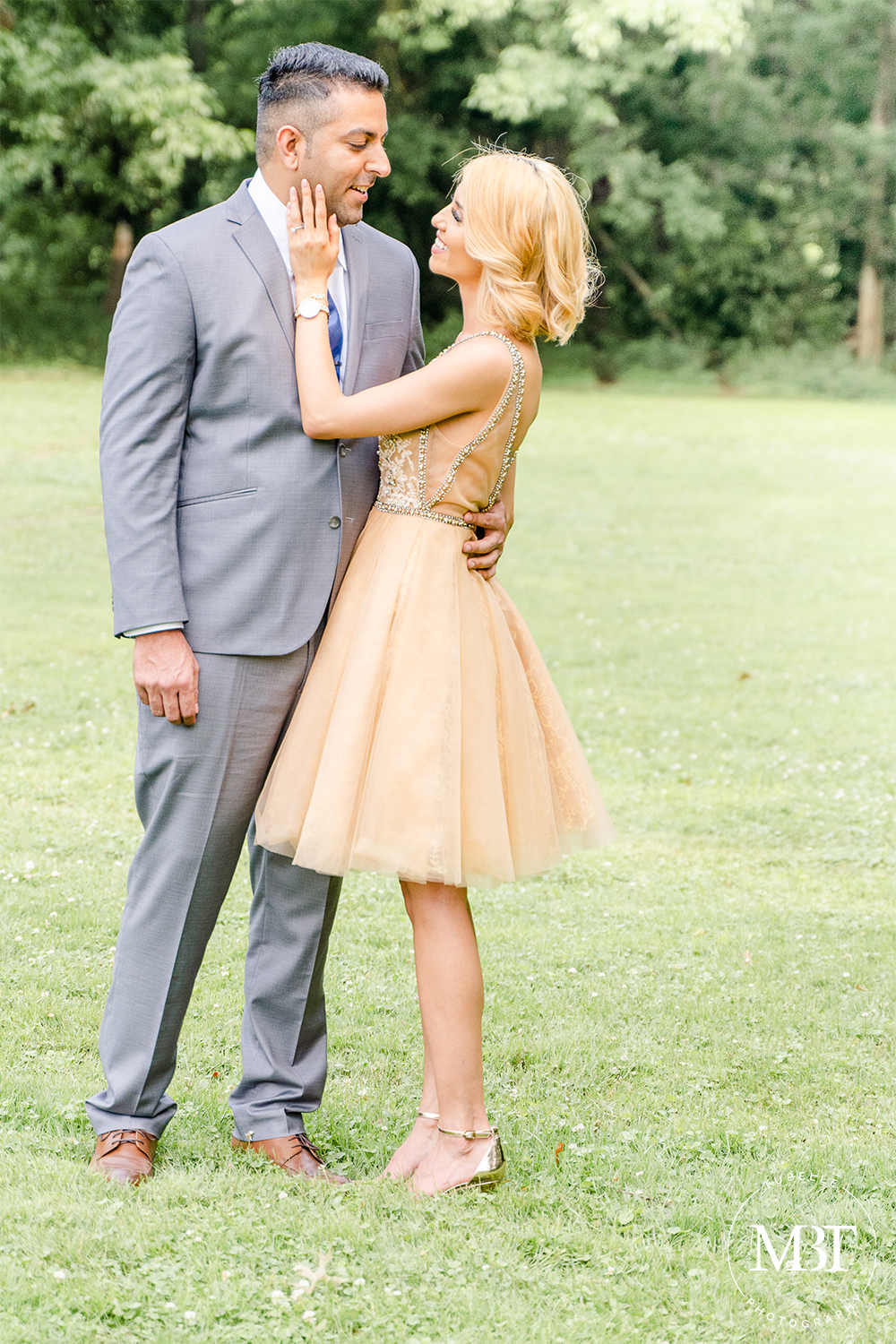 anniversary session, couple looking at each other wife holding husband's face while he wraps his arms around her, taken in Centreville, Virginia by a Northern Virginia portrait photographer