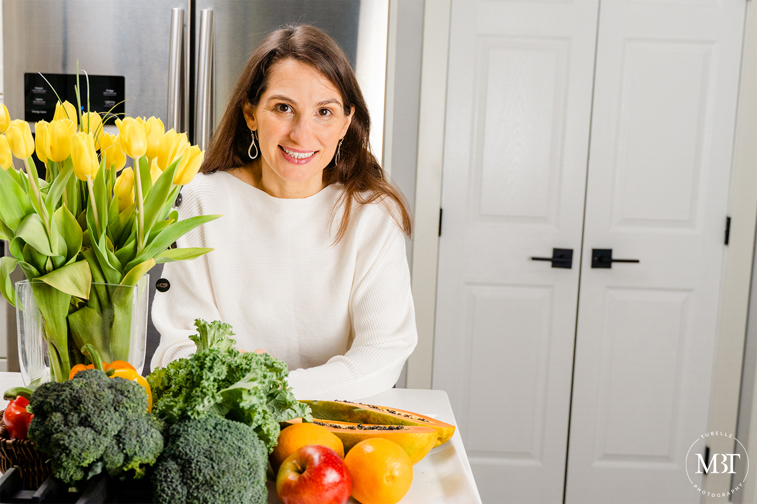 branding session - life coach with flowers, vegetables, and fruits in the kitchen, taken in Vienna, Virginia by a branding photographer in Northern Virginia