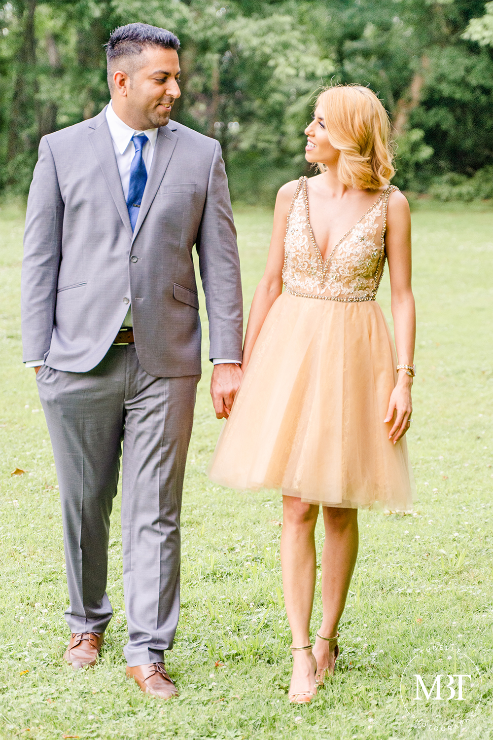 engagement session - engaged couple walking while looking at each other, taken in Centreville, Virginia by a Northern Virginia engagement photographer