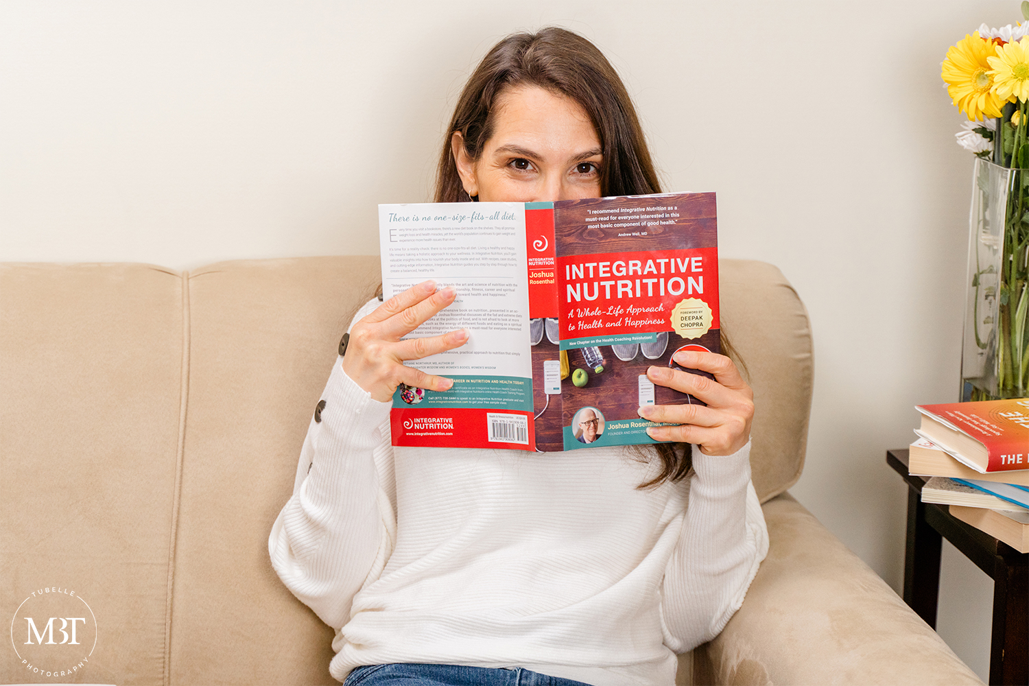lifestyle session - life coach in her living room couch reading a nutrition book, taken in Northern Virginia by a branding photographer in Washington, DC