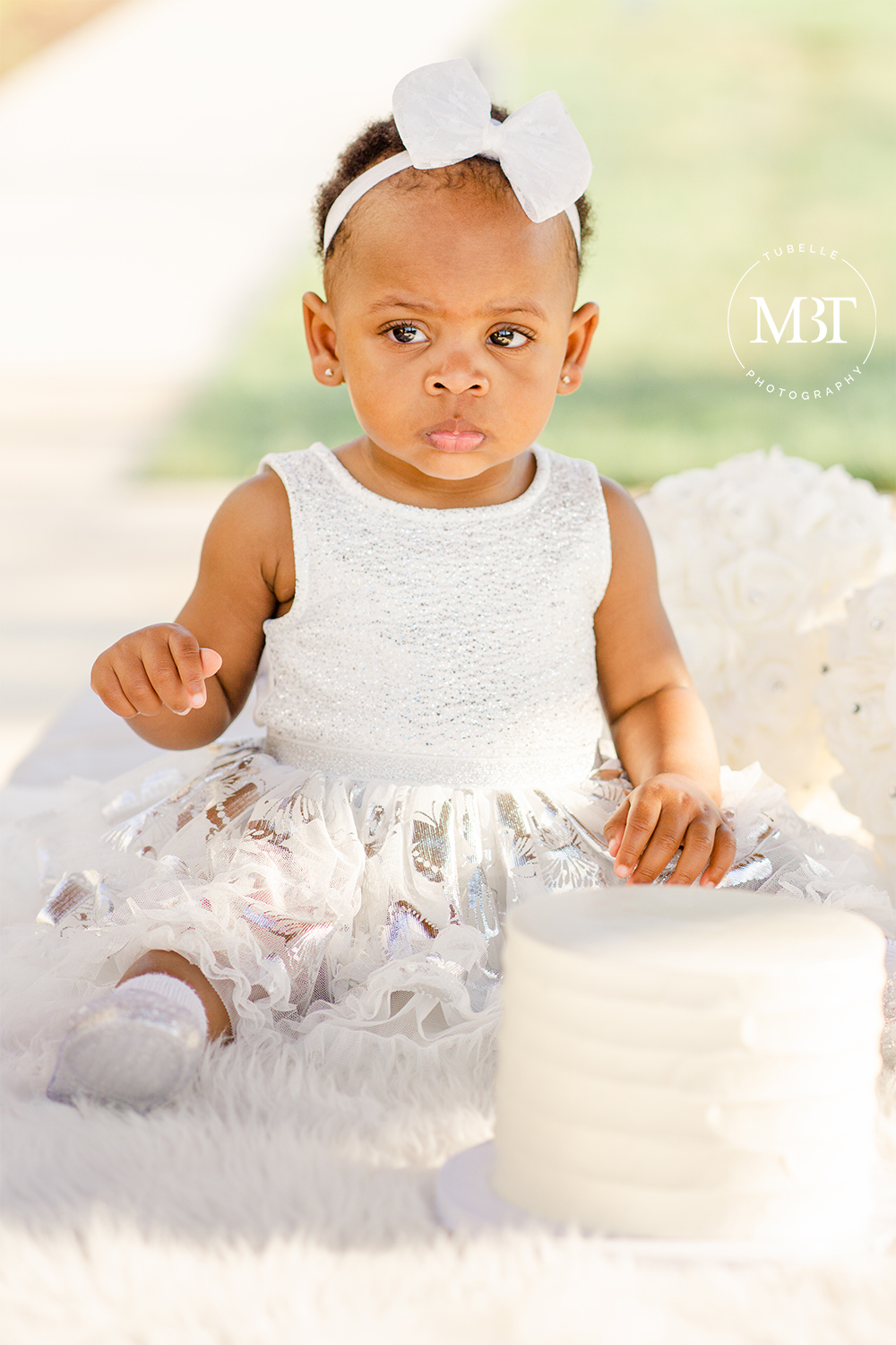 adorable toddler during a cake smash session, taken in Loudoun County by a Northern Virginia children's photographer