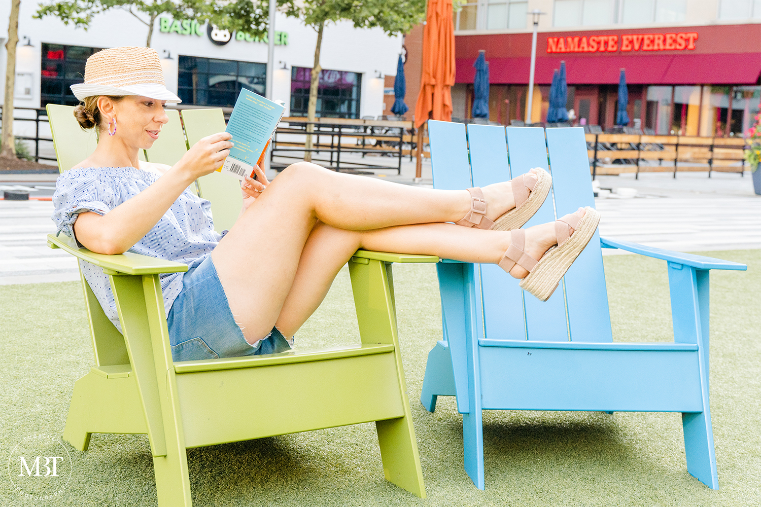 woman wearing off the shoulder top, denim shots reading a book, lifestyle session taken in Arlington, Virginia by a personal branding photographer in Northern Virginia