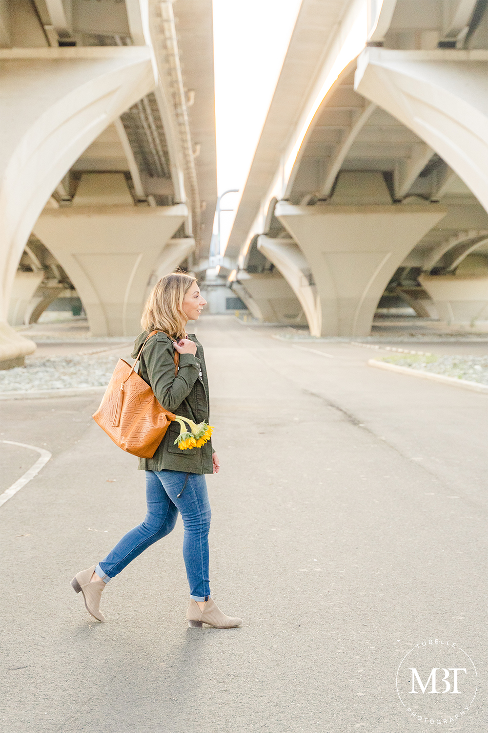 lifestyle session - fashion blogger walking under the Woodrow Wilson Bridge at Jones Point Park by a DMV lifestyle photographer