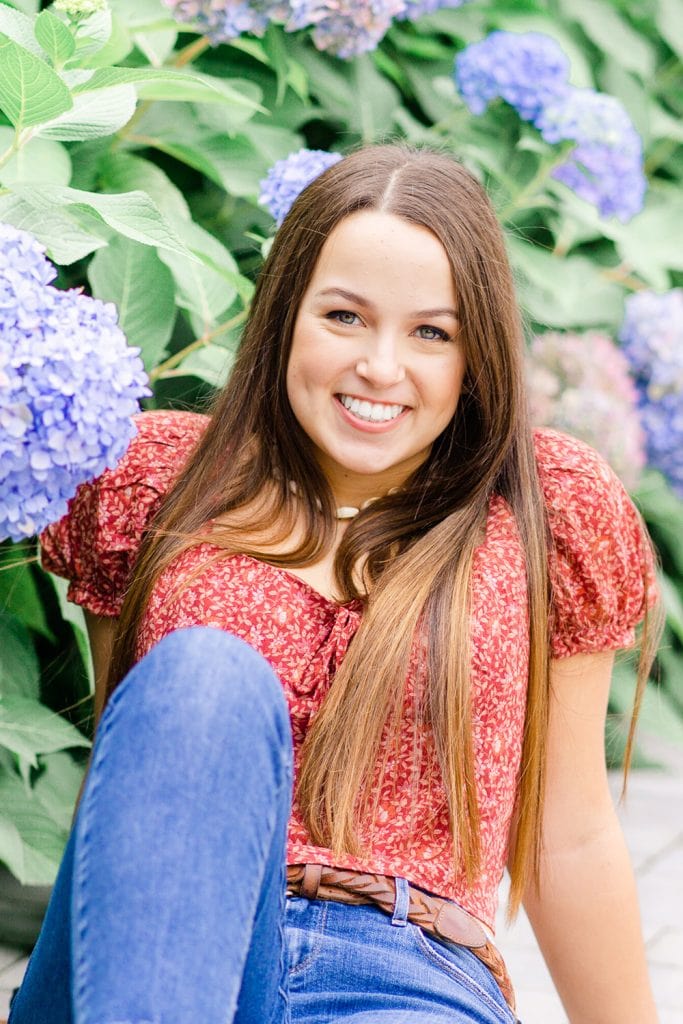 girl in front of hydrangeas taken by a senior photographer in Northern Virginia