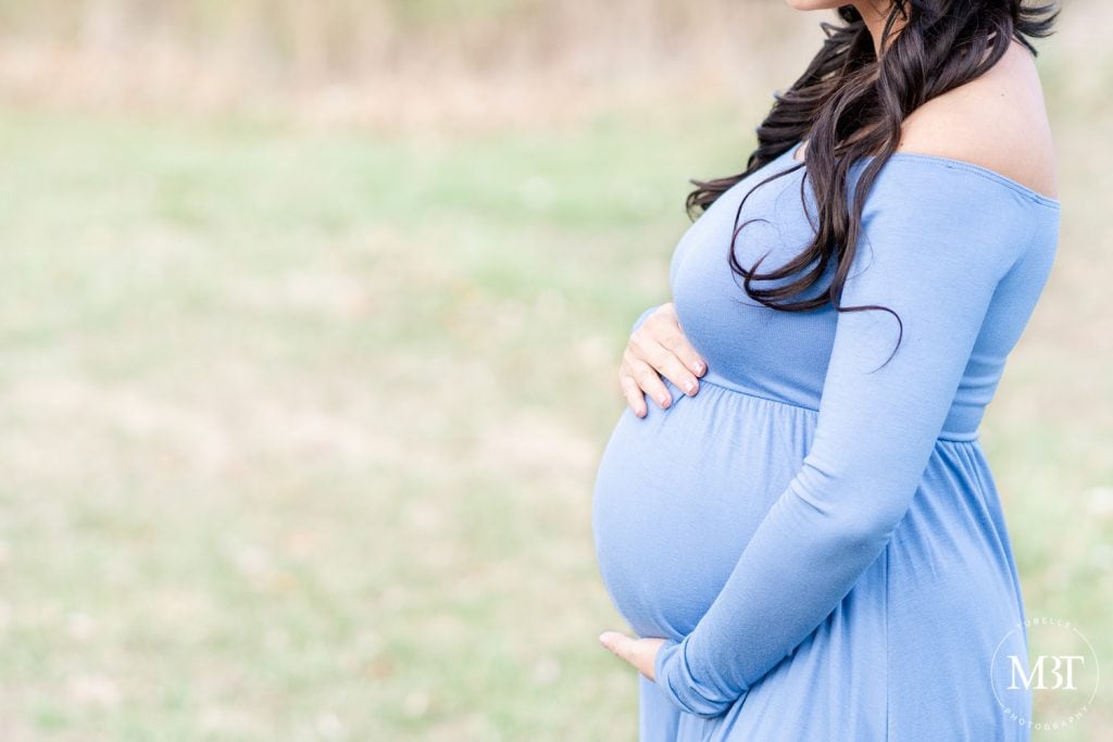 close up shot of pregnant belly during a maternity session in Gainesville, Virginia taken by a Virginia maternity photographer
