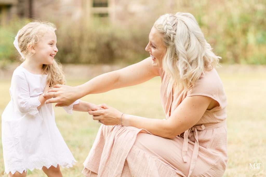 mommy tickling daughter during a family session in Chantilly, Virginia taken by a DMV family photographer
