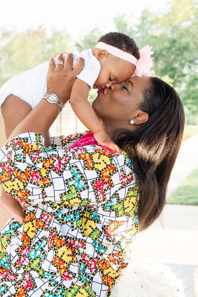 mom kissing daughter during their family session in Sterling, Virginia taken by a Loudoun County family photographer