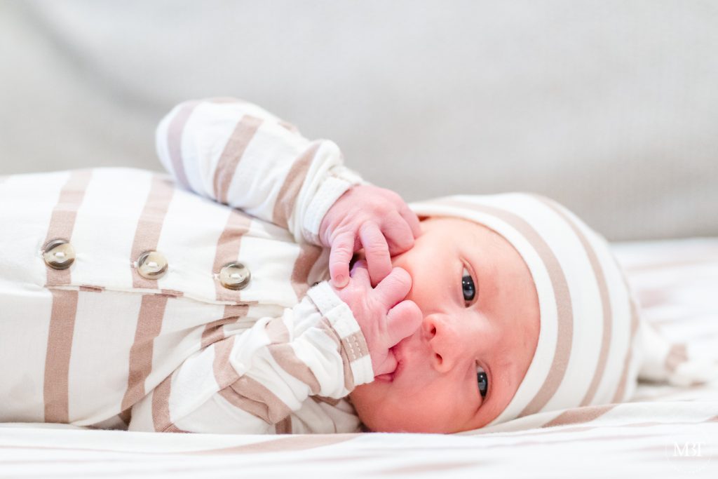 newborn baby sucking thumb during a newborn photography session in Northern Virginia by a Washington, DC photographer