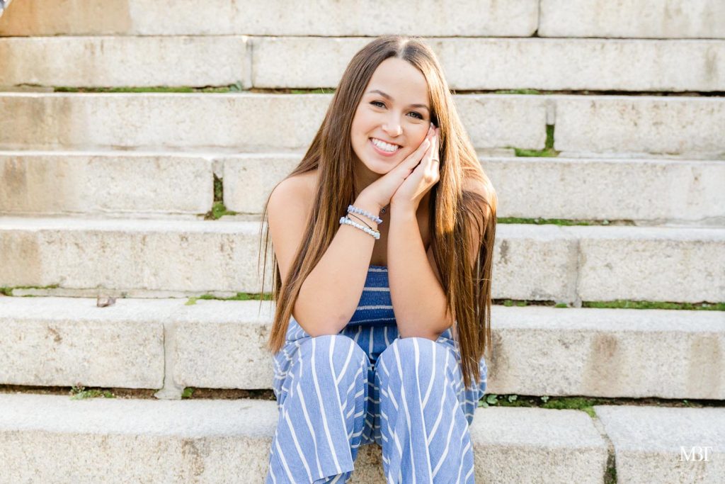 girl sitting by the stairs during a senior session at Airlie in Warrenton, Virginia taken by a Virginia senior photographer