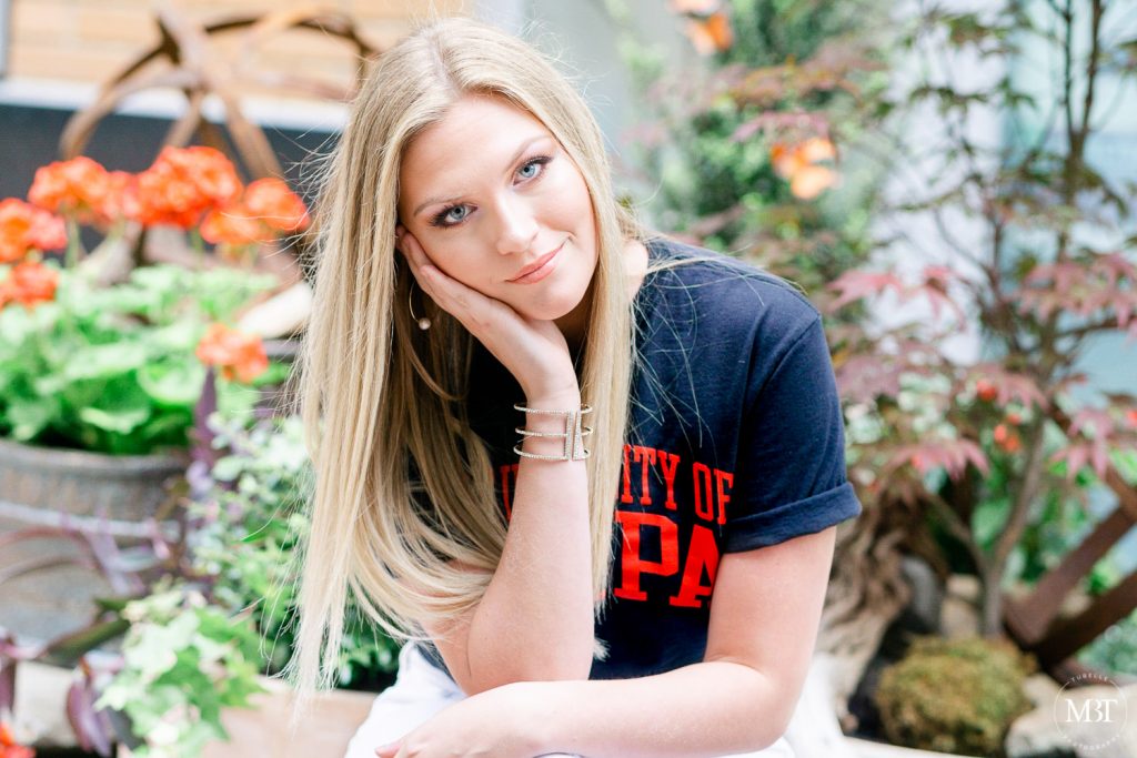 girl wearing a University of Tampa tee during her senior session at Reston Town Center taken by a Fairfax County Virginia senior photographer