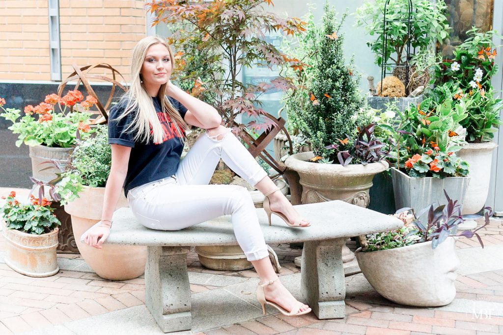 girl wearing University of Tampa tee during her senior session at Reston Town Center taken by a DMV senior photographer