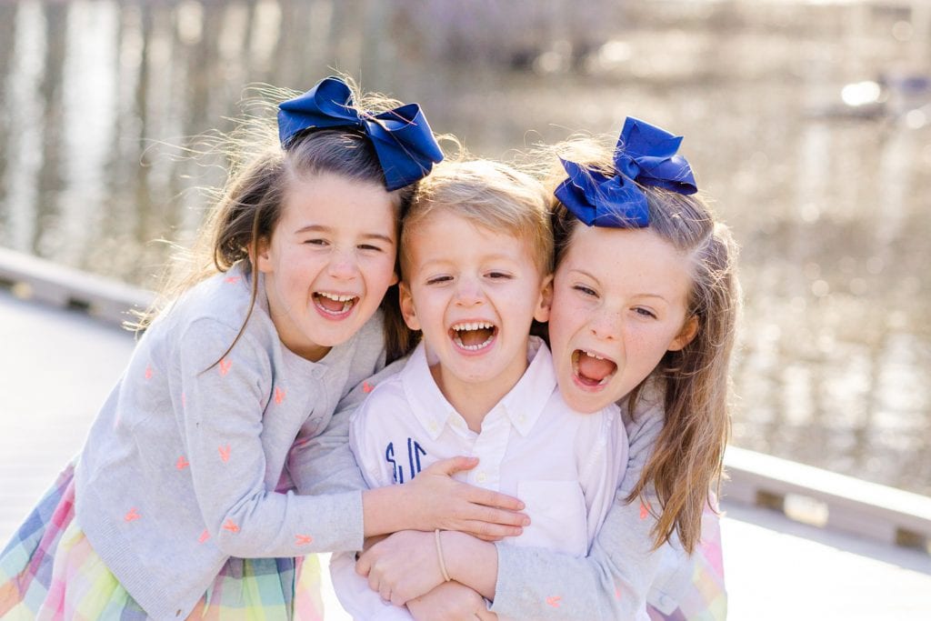 siblings laughing during their family session in Alexandria, Virginia by a Virginia family photographer