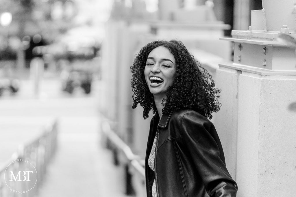 girl laughing during her urban senior session at Reston Town Center in Reston, Virginia taken by TuBelle Photography, a Virginia senior photographer