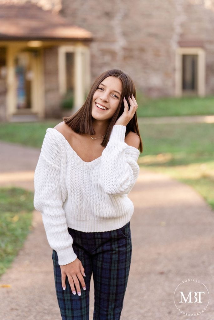 girl fixing her hair during her senior pictures taken in Chantilly, Virginia by TuBelle Photography, a Virginia senior photographer