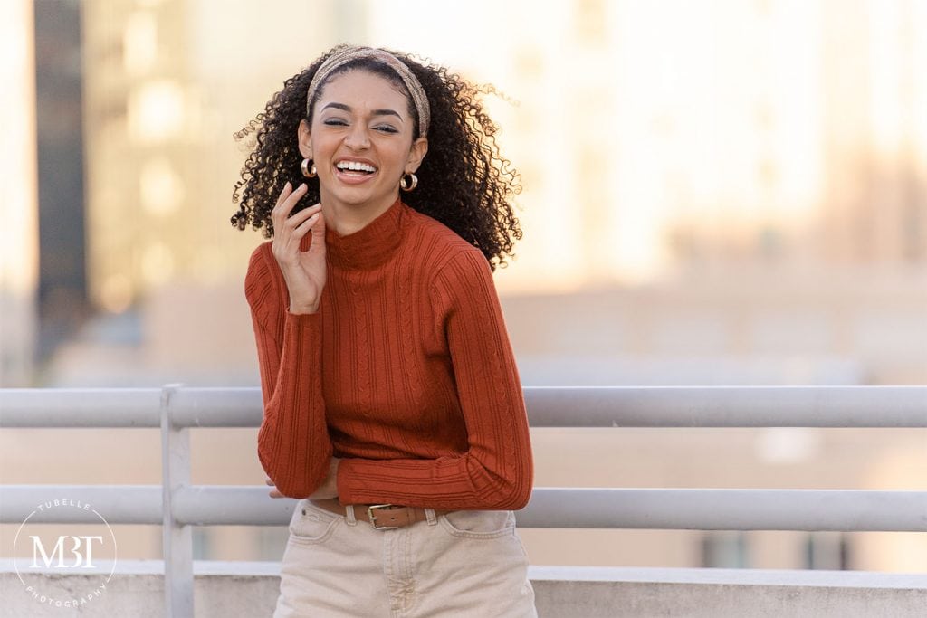 girl laughing on the parking garage during her urban senior photo shoot at Reston Town Center in Reston, Virginia taken by TuBelle Photography, a Northern Virginia senior photographer