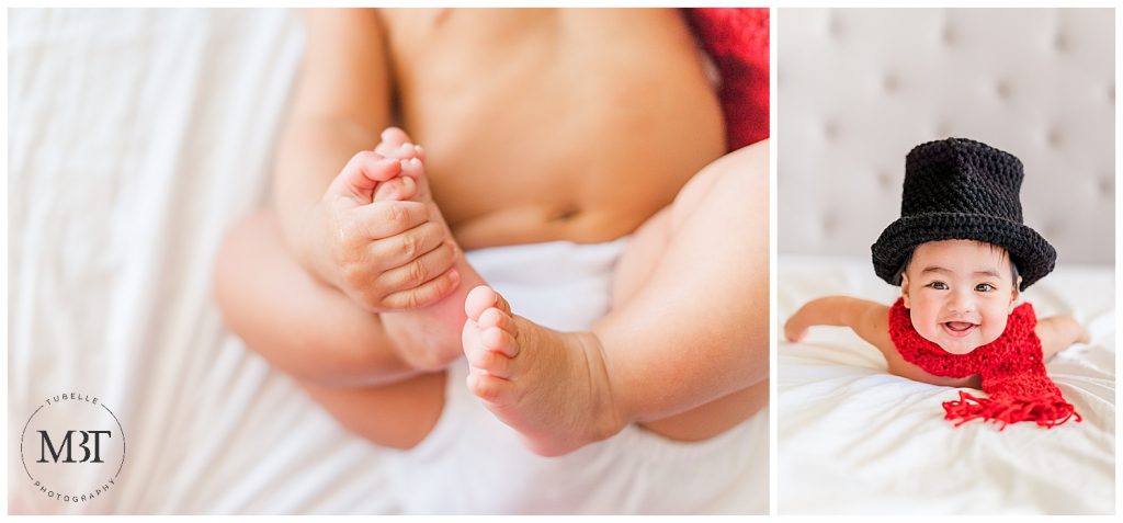 baby boy on his tummy wearing top hat and red scarf & playing with his feet during his milestone baby photo shoot in Fairfax, Virginia by TuBelle Photography, a baby photographer in Fairfax County
