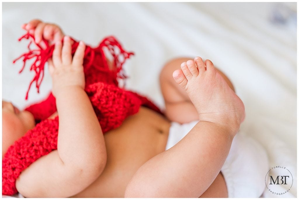 feet of a baby boy during his milestone baby photo shoot in Mclean, Virginia by TuBelle Photography, a baby photographer in Northern Virginia
