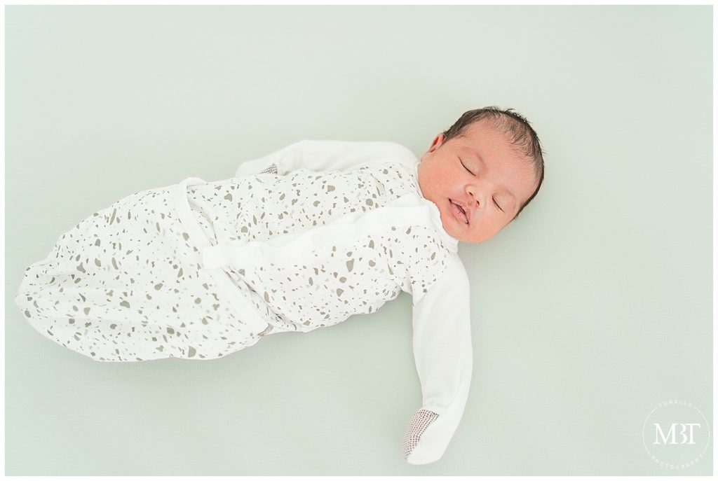 baby girl during their at home newborn portraits in Gainesville, Virginia, taken by TuBelle Photography, a Northern Virginia newborn photographer