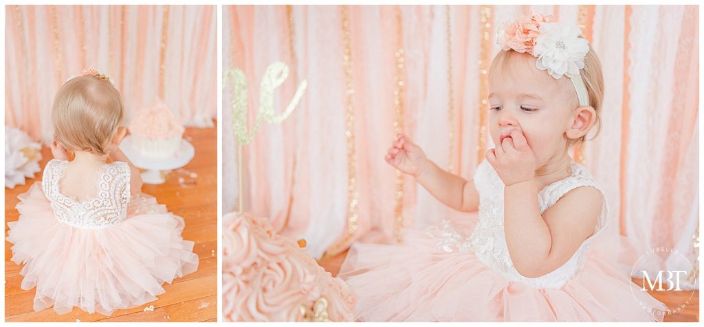 baby girl enjoying her cake during her cake smash photos in Gainesville, Virginia by TuBelle Photography, a NoVa cake smash photographer