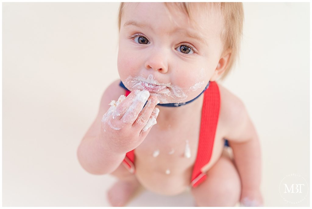 baby boy during his nautical themed cake smash session in Reston, Virginia taken by TuBelle Photography, a Northern Virginia cake smash photographer
