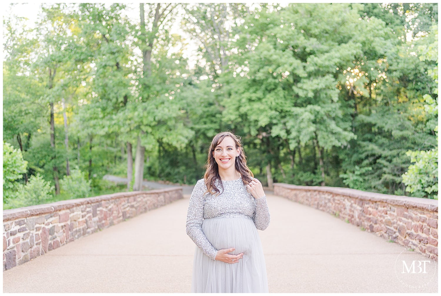 expecting mom fixing her hair during her Manassas, Virginia maternity portraits, taken by TuBelle Photography, a Prince William County maternity photographer